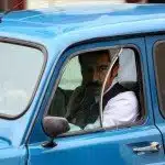 Kenan Imirzalioglu driving blue car